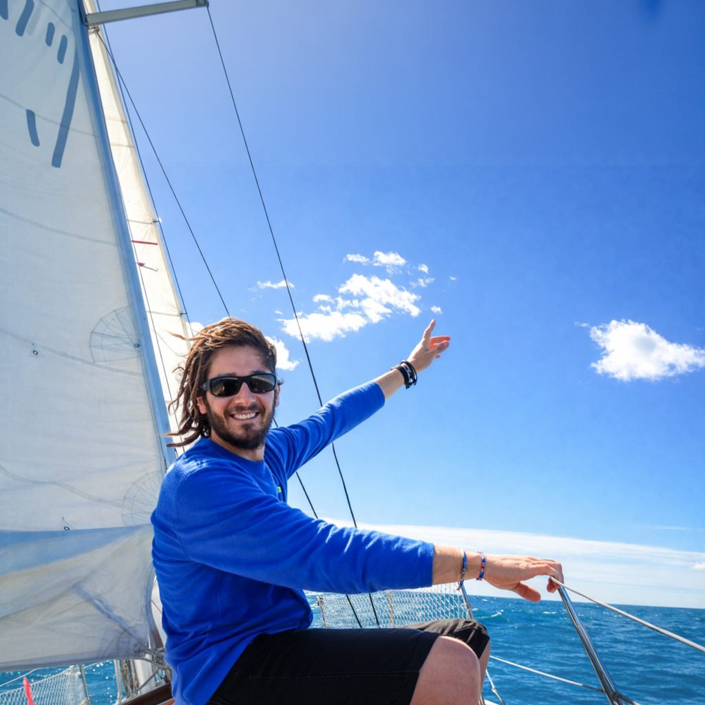 A skipper is smailing on is sailing boat