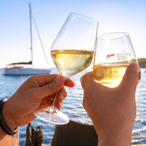 Small group enjoying a sailing experience in Barcelona with drinks onboard